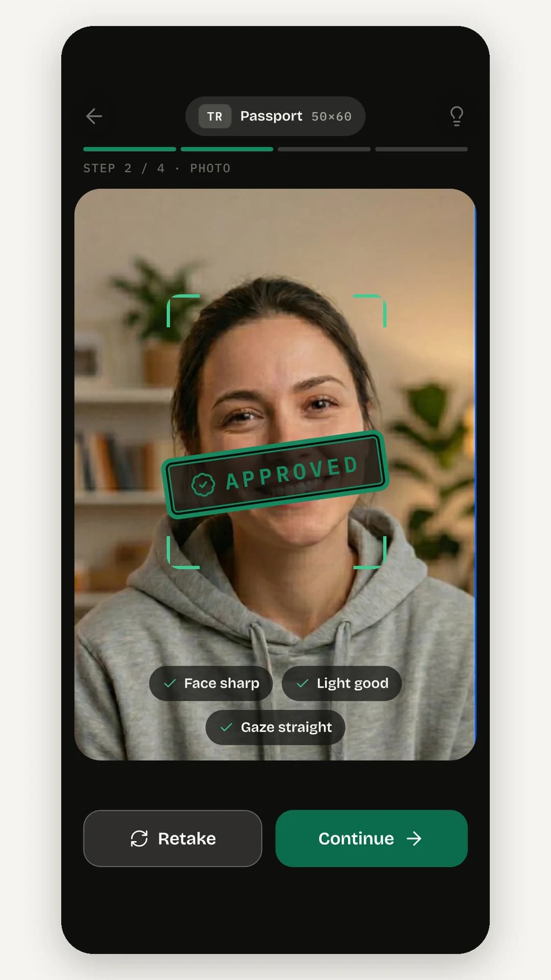 The photo step in the camera view: a face inside green viewfinder brackets with an Approved stamp, chips for face sharp, light good and gaze straight, and Retake and Continue buttons
